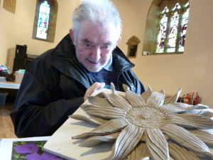 man displaying clay flower